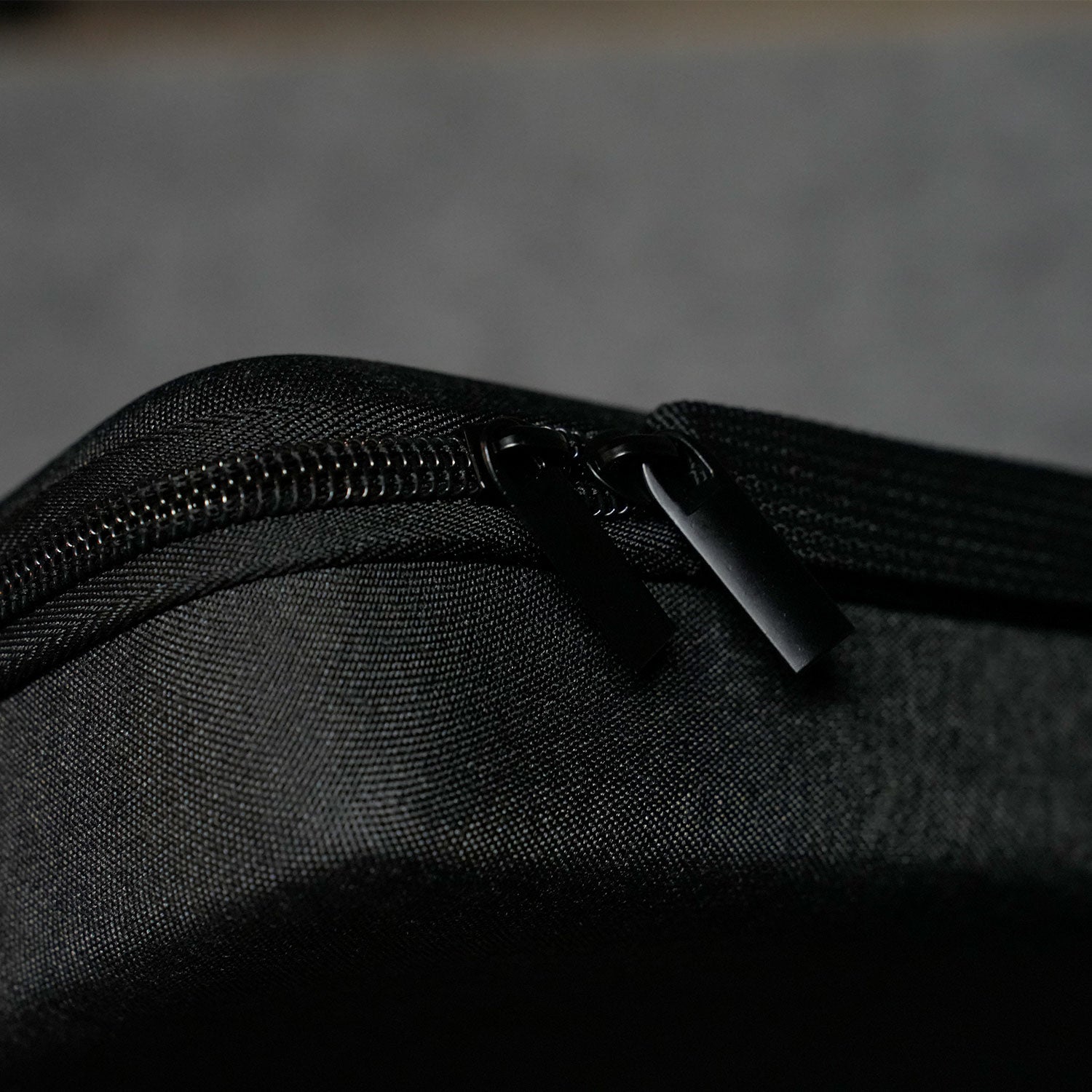 Close-up of a MonsGeek Keyboard Carrying Case on a textured black surface