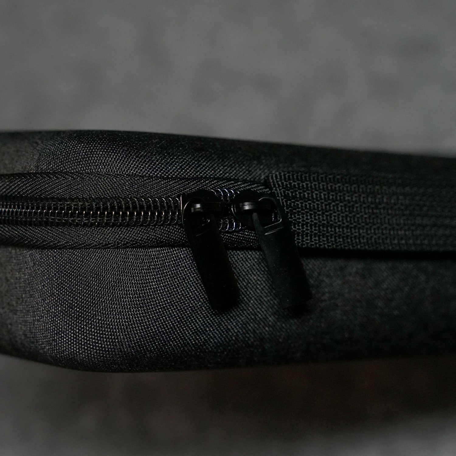 Close-up of a MonsGeek Keyboard Carrying Case on a textured black surface