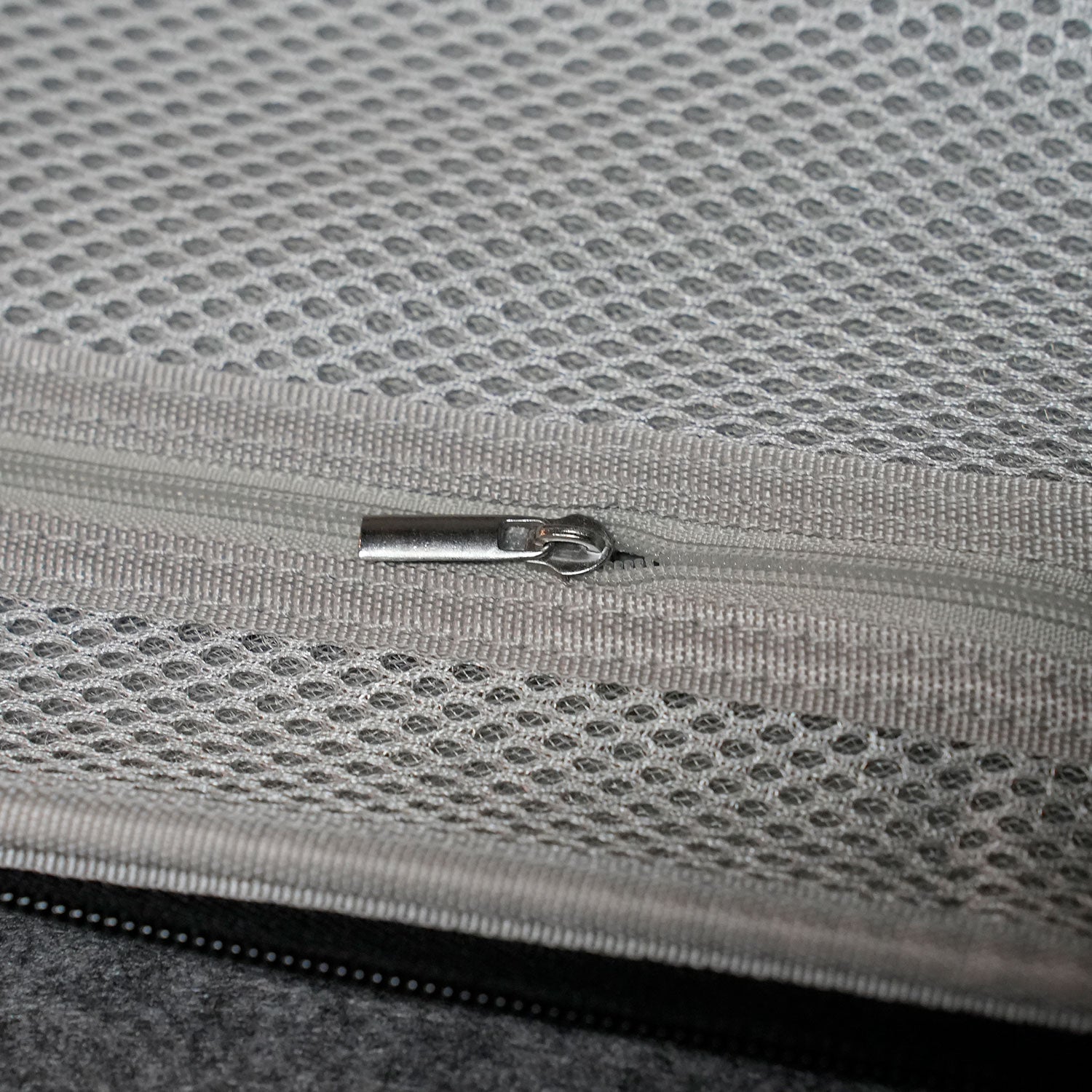 Close-up of a MonsGeek Keyboard Carrying Case on a textured gray fabric surface