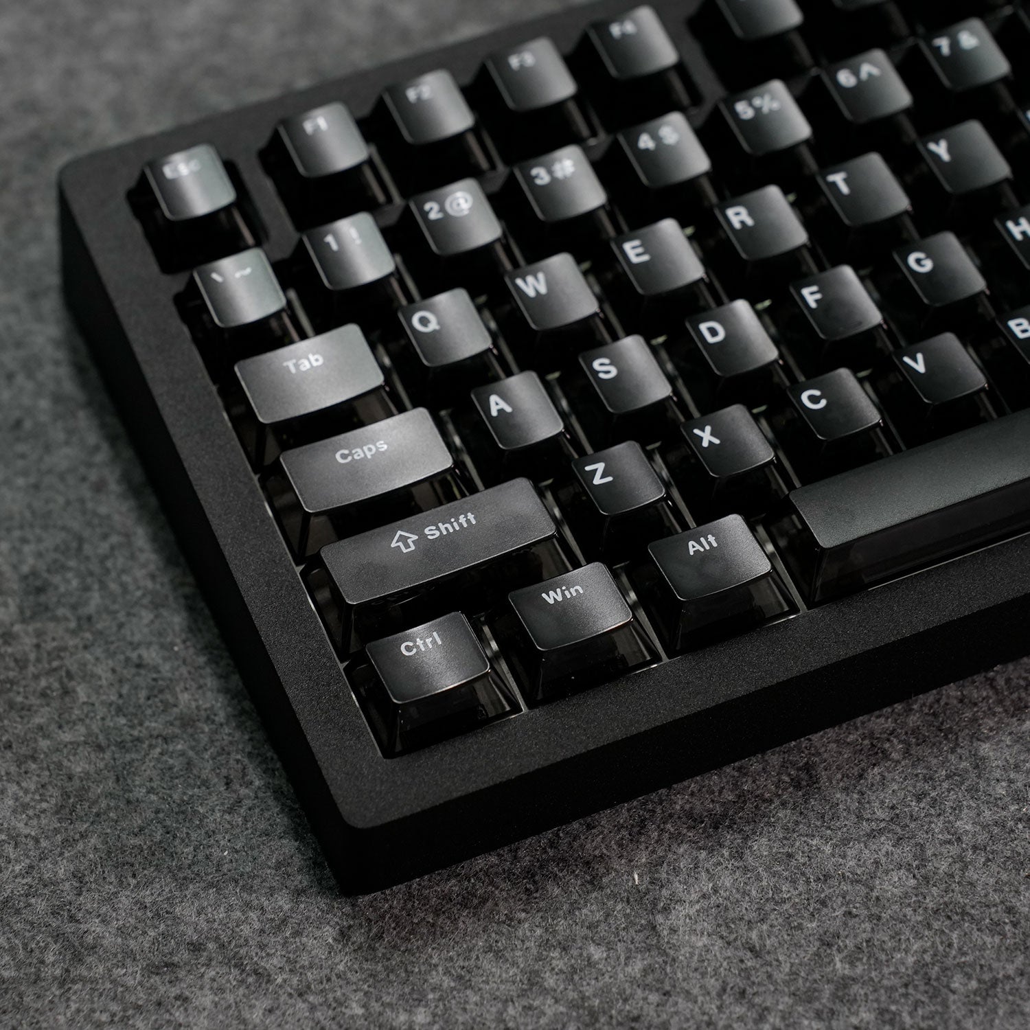 Close-up of a MonsGeek M1 V5 HE Magnetic Keyboard on a textured surface