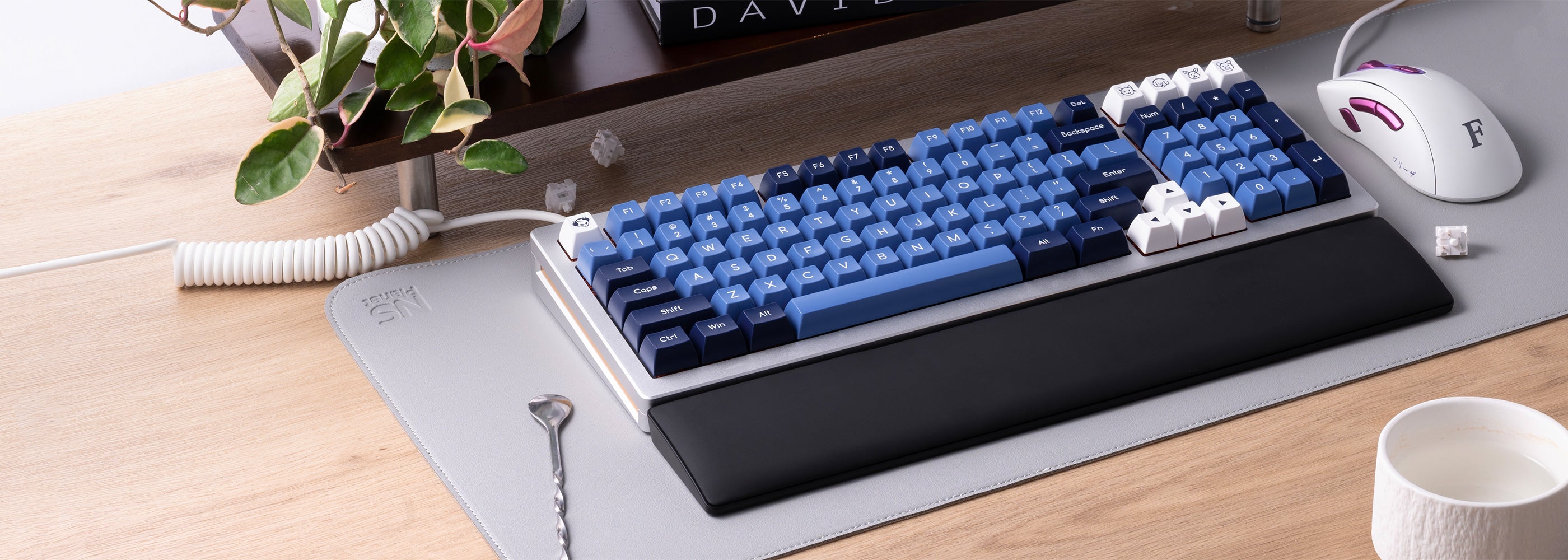 Black Monsgeek wrist rest, a sleek keyboard and mouse positioned on a modern desk surface.