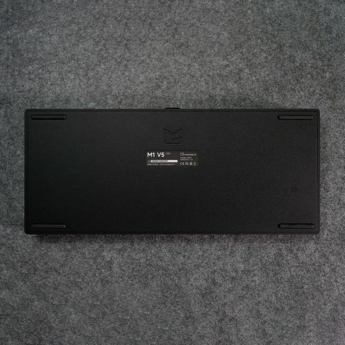 Black MonsGeek M1 V5 HE Magnetic Keyboard Back Details on a gray textured surface